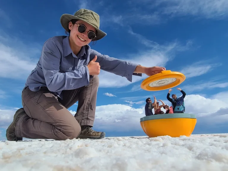 Bolivia salt flats tour group illusion of girl putting group in pot