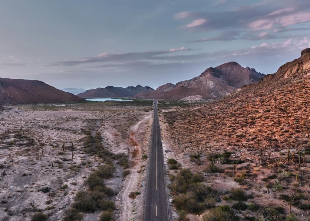 Aerial photo of a remote road through Bolivian mountains at dusk