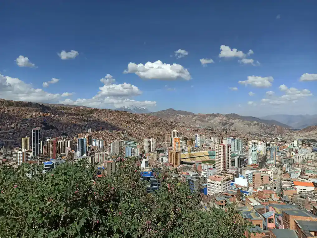 A panoramic view of a showing the high altitude of La Paz with densely packed high-rise buildings and colourful architecture.