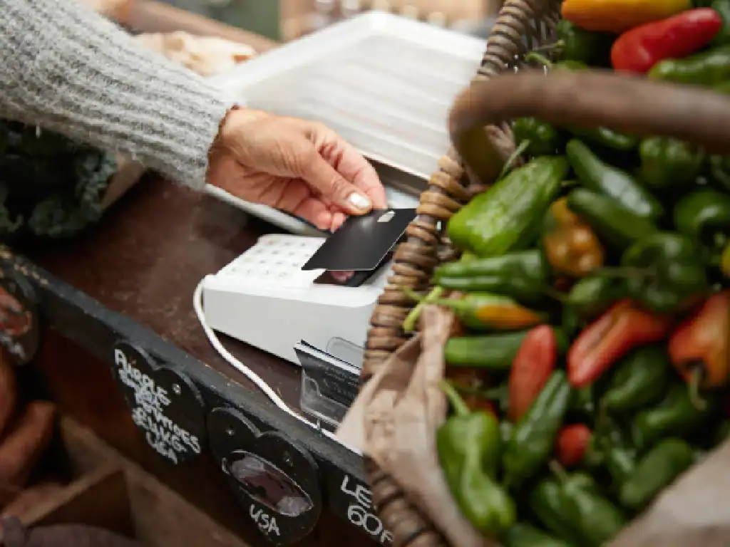 Traveller paying with card at a local market in Bolivia.