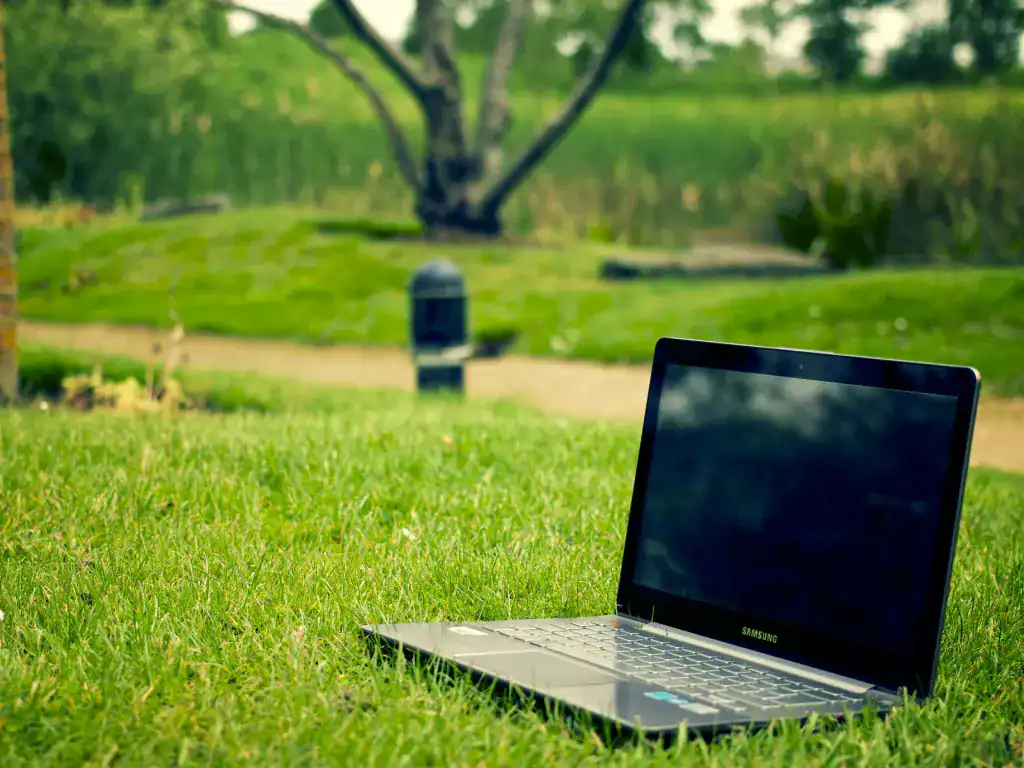 Laptop outdoors in a green park setting representing remote work in Bolivia.