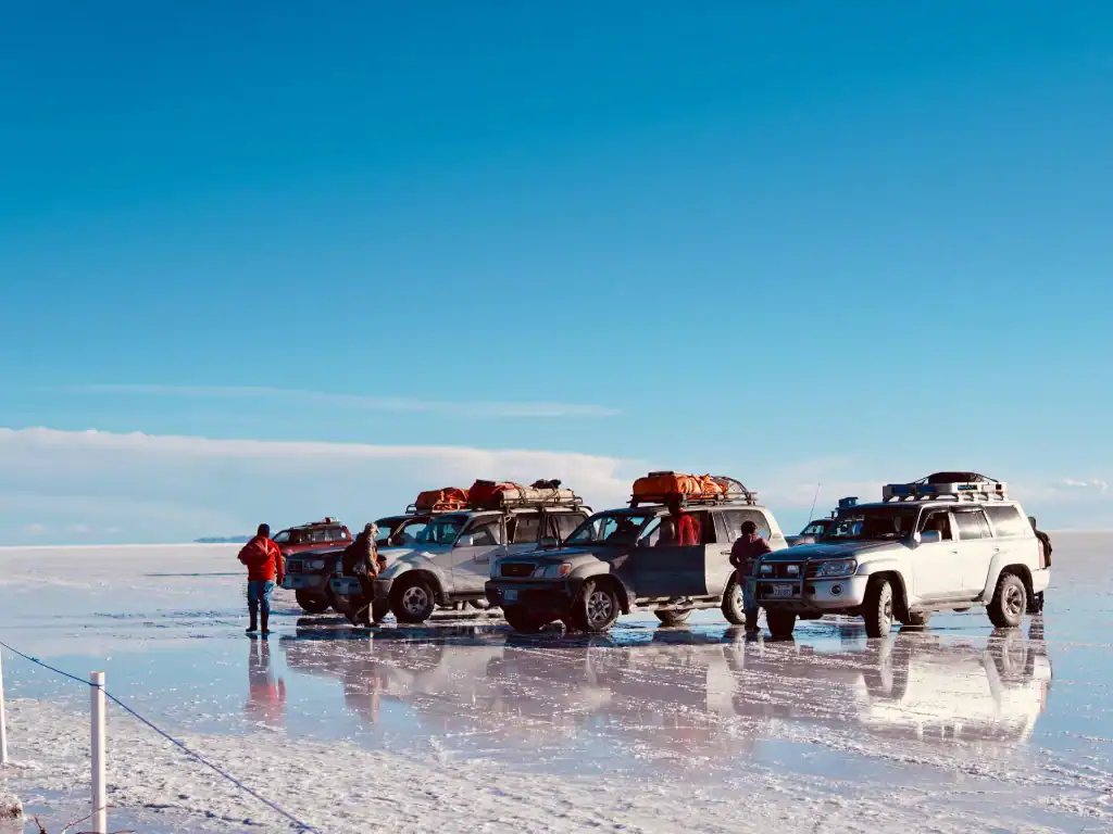 Travellers relaxing at a remote salt flat during a Bolivia group tour.