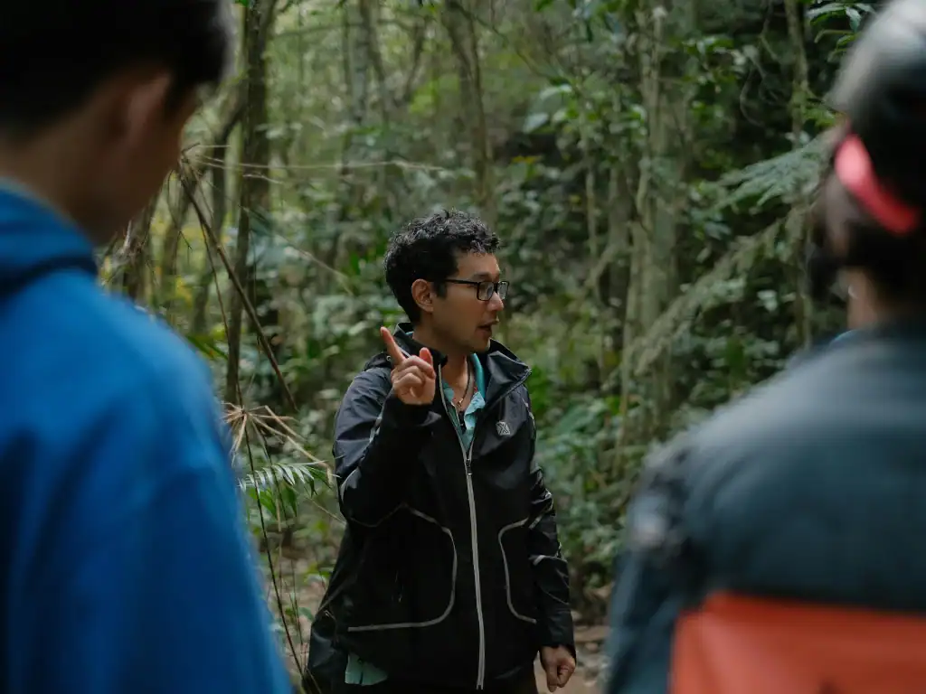 Local guide leading travellers through a rainforest tour in Bolivia.