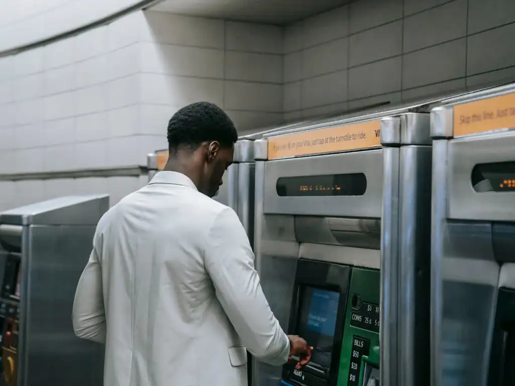 Cash being withdrawn from an ATM, highlighting the importance of checking machines before use.