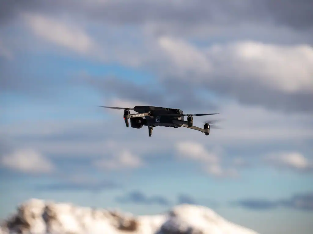 Drones Bolivia flying above a mountainous landscape while capturing aerial footage