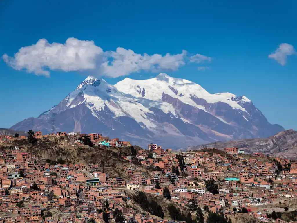 Illimani mountain rising above the hillside neighbourhoods of La Paz, Bolivia.
