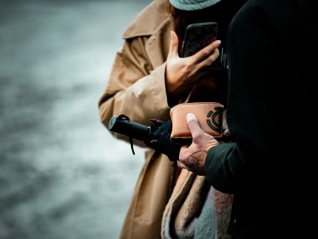 Close-up of a potential pickpocket situation involving a wallet in a crowded public setting in Bolivia