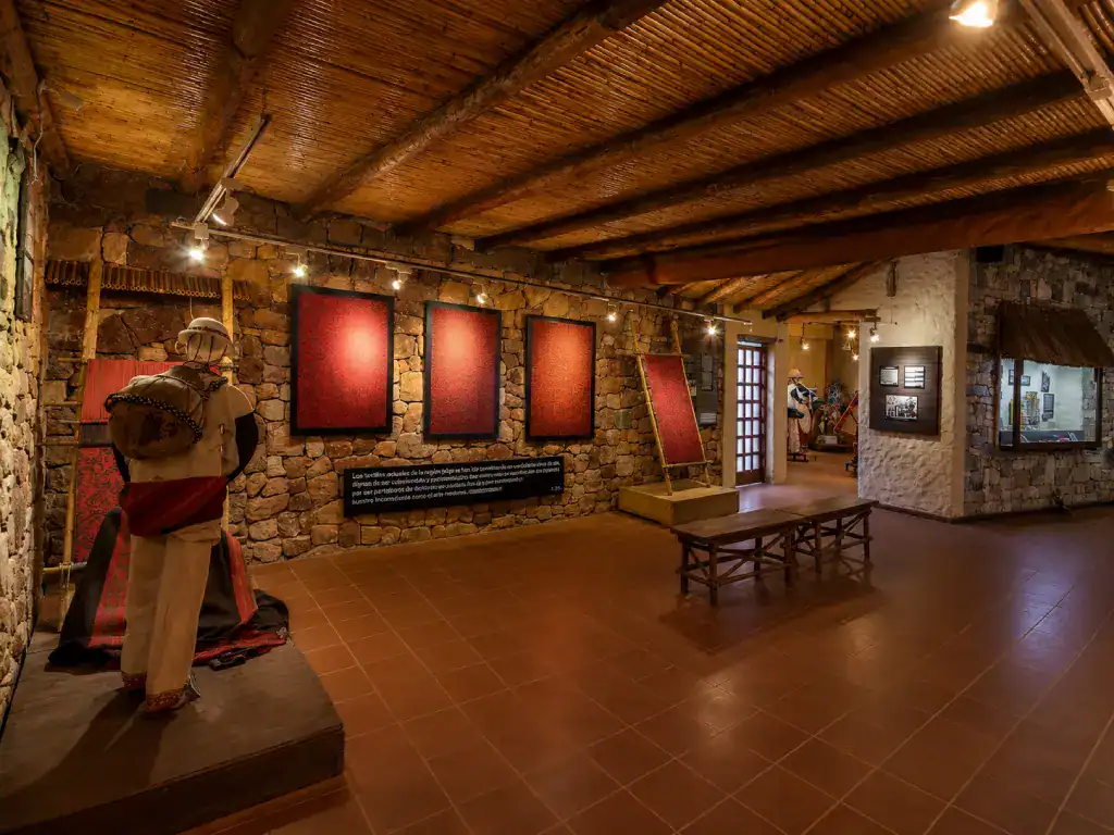 Interior of the ASUR Textile Museum displaying traditional Andean woven textiles and cultural exhibits in Sucre.