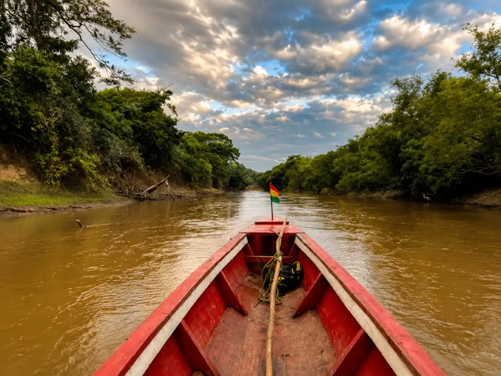Traditional red river boat travelling through the Bolivian Amazon near Rurrenabaque
