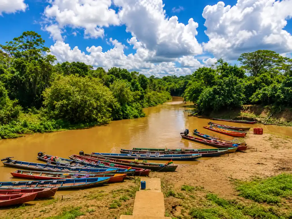 Colourful wooden boats moored along the muddy Beni River in Rurrenabaque, Bolivia