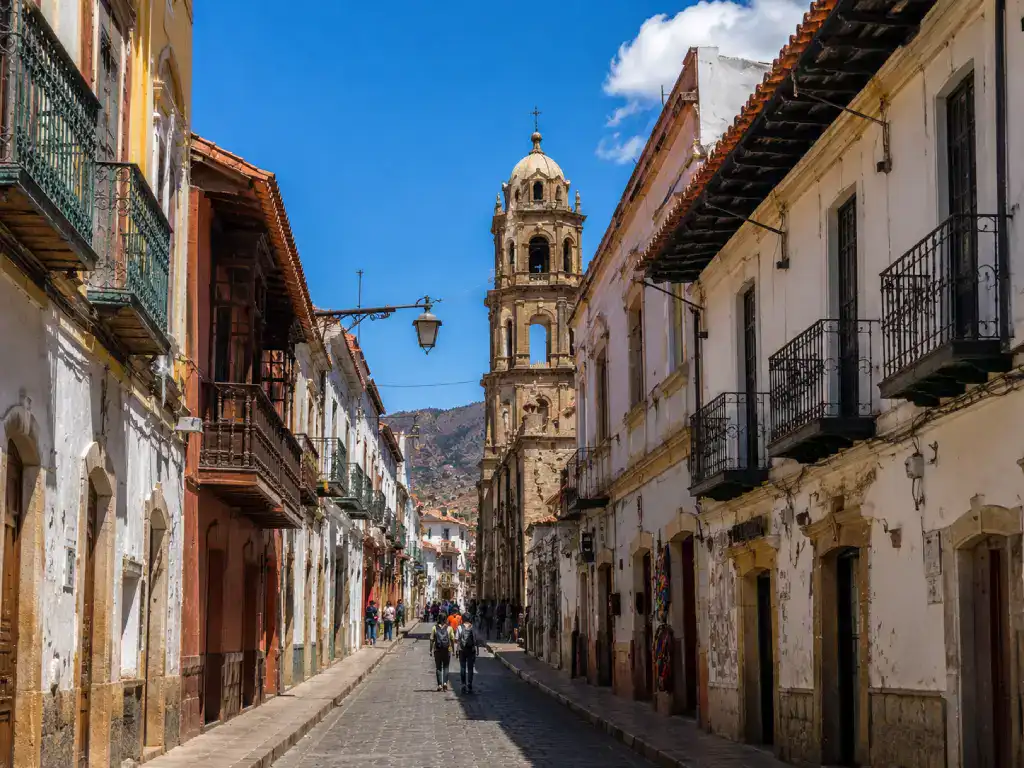 Colonial street in the historic centre of Potosí lined with colourful balconies and traditional architecture.