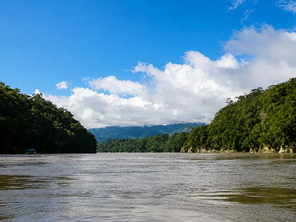 Wide river winding between rainforest-covered hills in the Bolivian Amazon