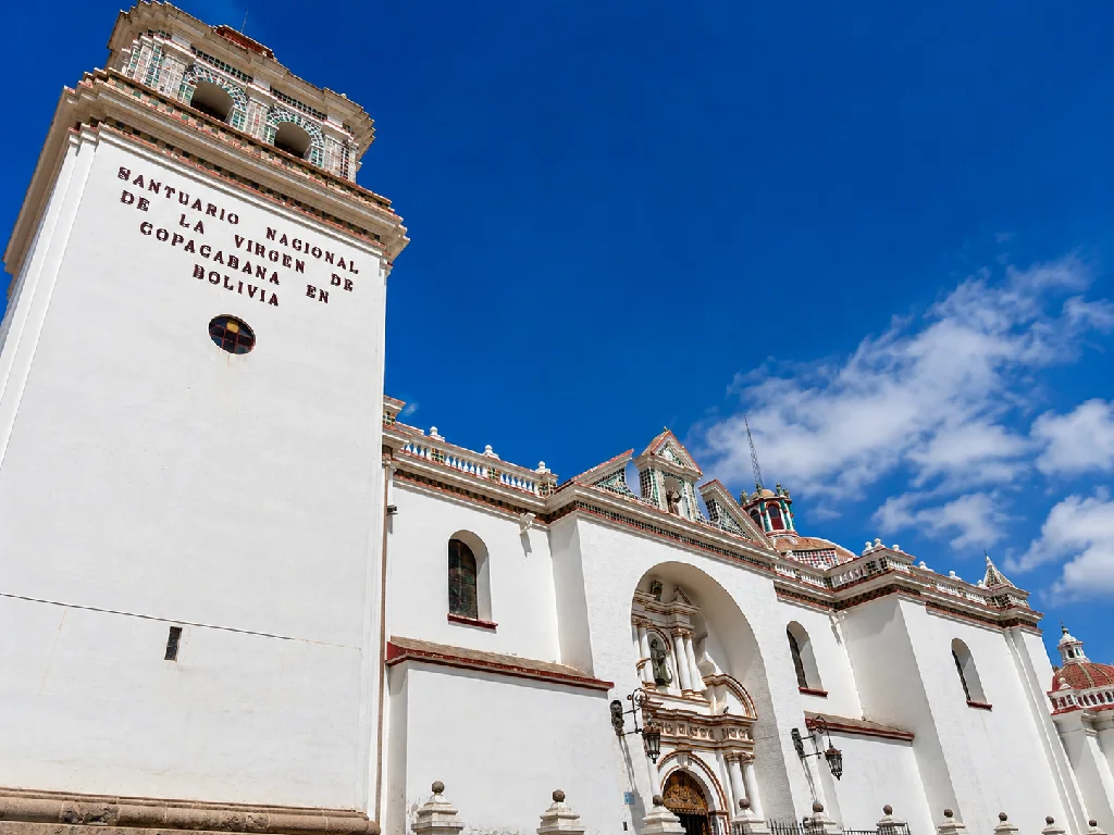 Exterior of the Basilica of Our Lady of Copacabana in Bolivia beneath a clear blue sky.