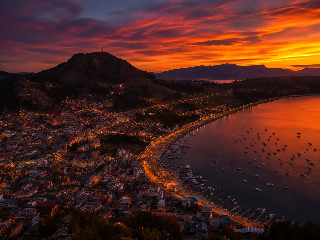 Sunset over Copacabana Bolivia and Lake Titicaca with glowing evening lights.